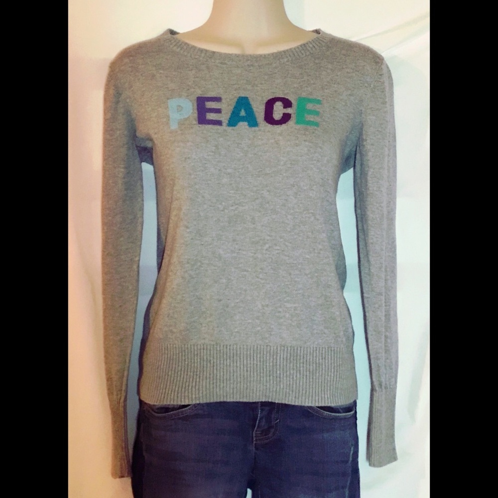 Light gray sweater w/ “Peace” written across front